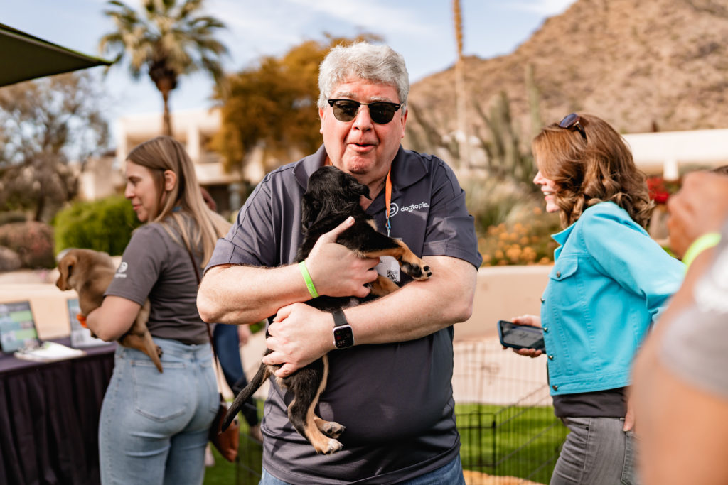 Man holding small dog in arms