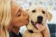 Woman kissing dog's cheek