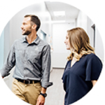 Man and woman walking beside each other looking off camera