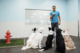 Dogtopia Canine Coach teaching commands to five dogs inside playroom